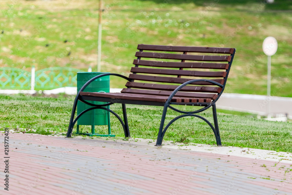 Wooden bench with a urn in the park