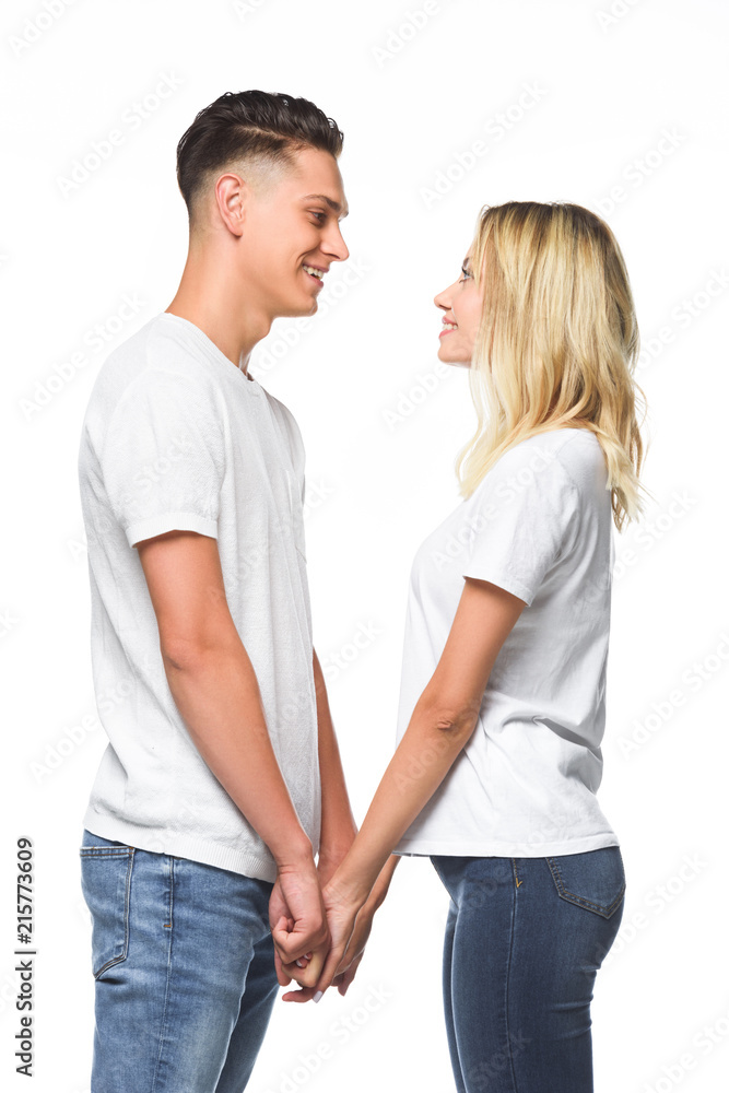 side view of couple holding hands and looking at each other isolated on white side view of couple holding hands and looking at each other isolated on white