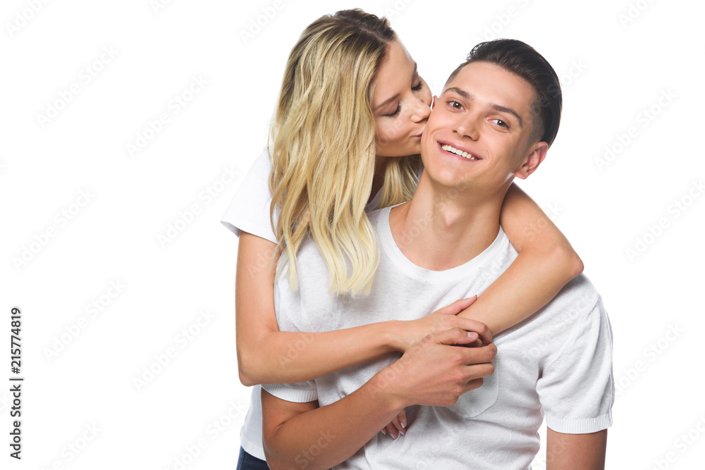 girlfriend kissing smiling boyfriend isolated on white girlfriend kissing smiling boyfriend isolated on white