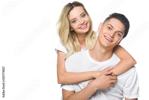 smiling girlfriend hugging boyfriend isolated on white © LIGHTFIELD STUDIOS
