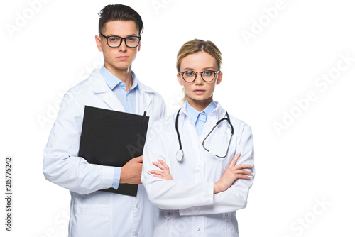 serious doctors standing with stethoscope and clipboard isolated on white