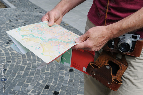 Photography A man is holding a tourist map.