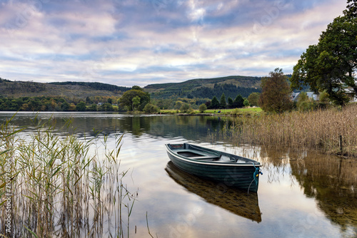 Evening light on a rowing boat on the banks of Loch Ard in the Trossachs 