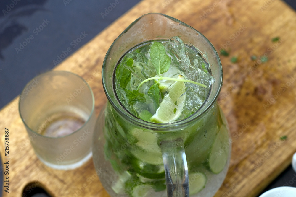 cold summer drink with lime and mint on a wooden board top view cold summer drink with lime and mint on a wooden board top view