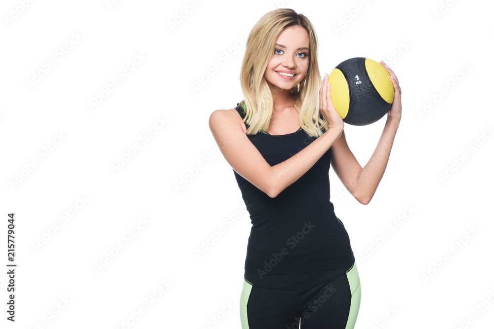 smiling young woman with medicine ball looking at camera isolated on white smiling young woman with medicine ball looking at camera isolated on white