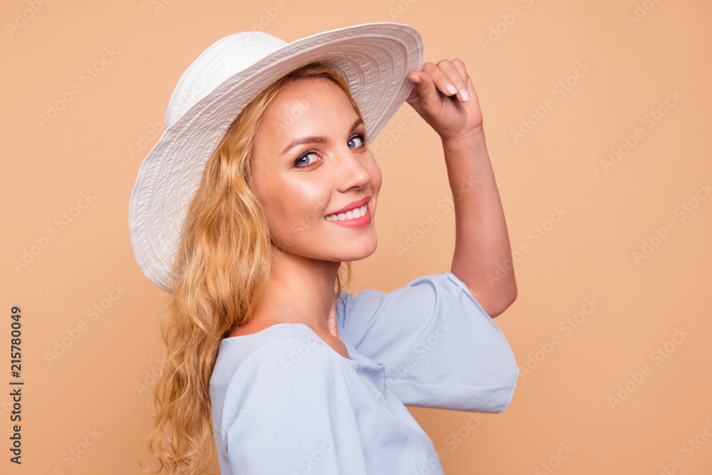 Portrait of young lovely attractive caucasian curly-haired charming gorgeous smiling confident woman wearing sunhat. Isolated over pastel yellow background Portrait of young lovely attractive caucasian curly-haired charming gorgeous smiling confident woman wearing sunhat. Isolated over pastel yellow background