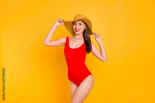 Closeup photo portrait of nice lovely cute careless with toothy beaming smile slim fit lady touching wide brimmed straw hat isolated on shiny vivid colorful background