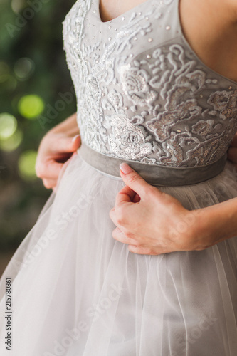 Bride wearing gray fashionable silk wedding dress embroidered with lace, beads and bugles