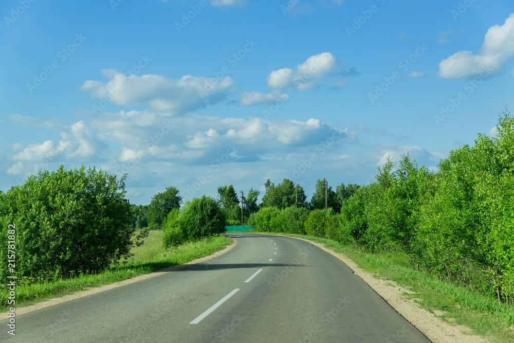 empty car road through the forest in summer day in Russia