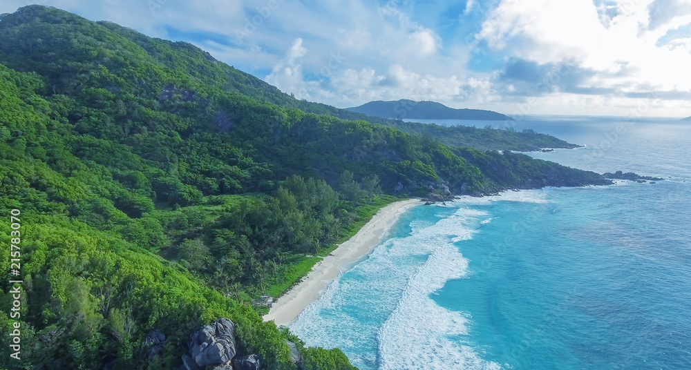 Panoramic view of Seychelles mountains and coastline from drone on a sunny day
