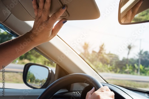 Wallpaper Mural Lady adjust sun visor while driving car on highway road - interior car using concept Torontodigital.ca