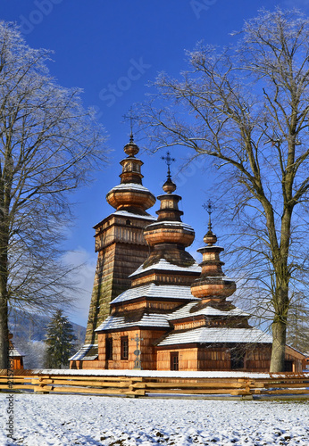 Beautiful ancient greek catholic wooden church in village of Kwiaton in winter, inscribed on the UNESCO World Heritage list, Low Beskid (Beskid Niski), Poland
