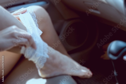 Young lady pull her panty liner while sitting in a car - sex in car dangerous drive behave concept