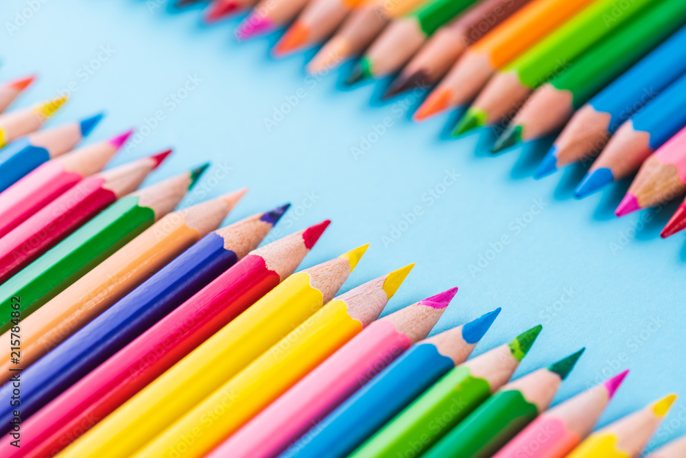 Education or back to school Concept. Close up macro shot of color pencil pile pencil nibs on blue background. Education or back to school Concept. Close up macro shot of color pencil pile pencil nibs on blue background.