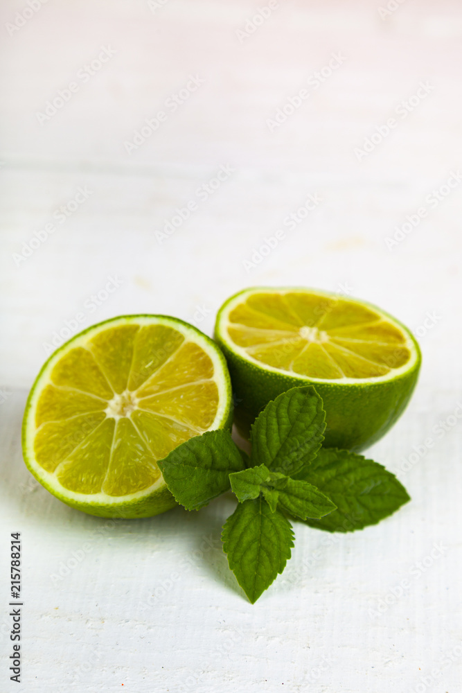 Lime and mint on a white table. Lime and mint on a white table.