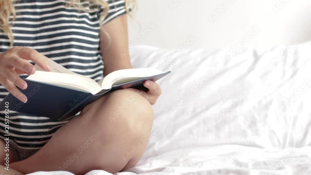Close up of woman reading a book and realxing at home on white background. Turning the page. Copy space Close up of woman reading a book and realxing at home on white background. Turning the page. Copy space