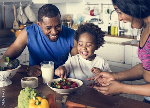 Black family eating healthy food together photo