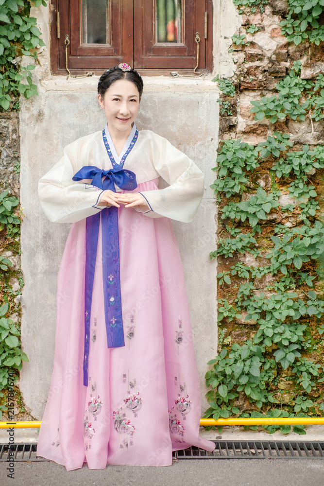 Woman wearing Hanbok Korean traditional dress costume walk and