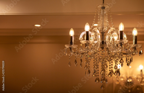 Chrystal chandelier lamp on the ceiling in Dining room Adjusting the image in a Luxury tone .Decorative elegant vintage and Contemporary interior Concept.