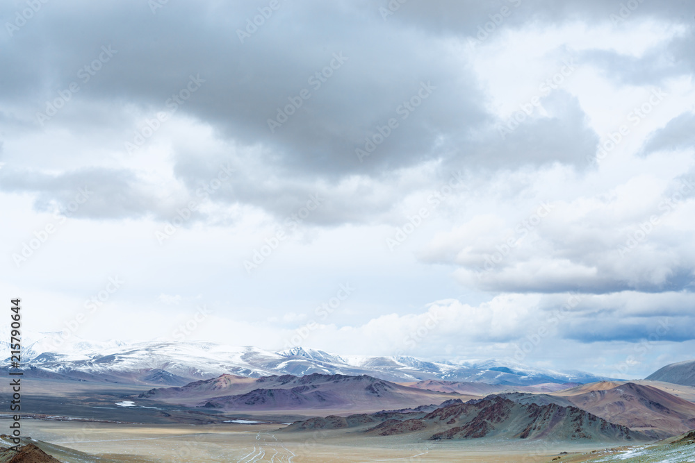 Panoramic view of snowy mountains under cloudy sky
Panoramic view of snowy mountains under cloudy sky