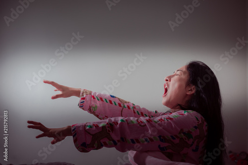 Fotografie Asian woman sleepwalk in her sleep have a nightmare .