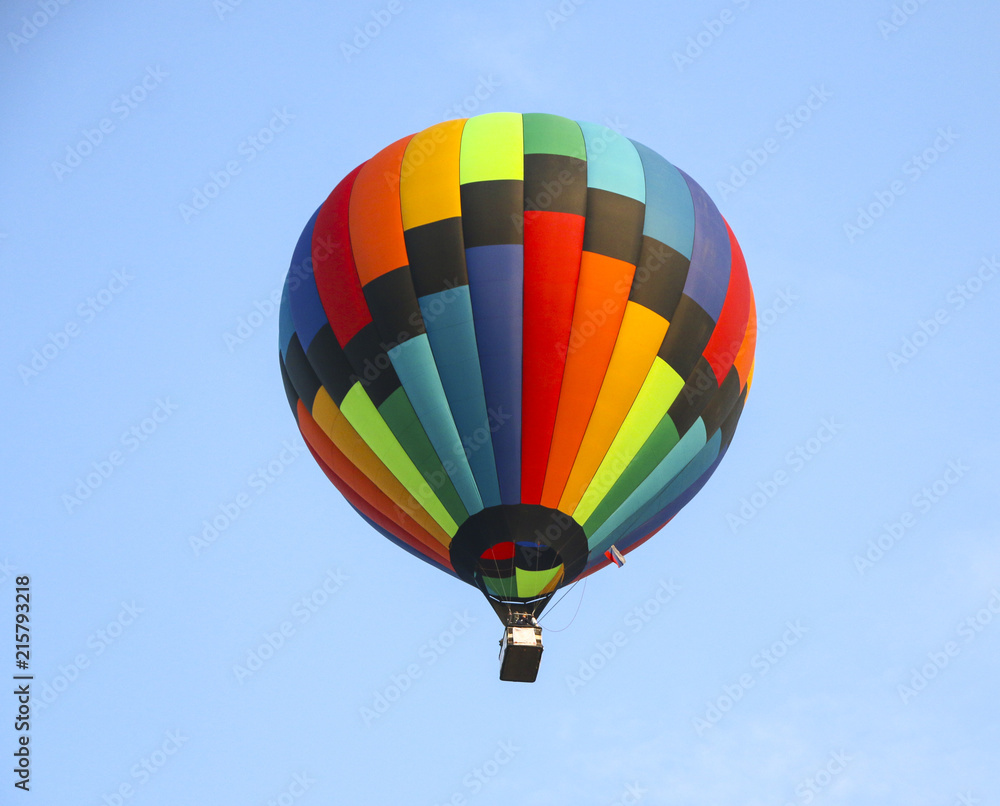colorful hot air balloon against blue sky. hot air balloon is flying in white clouds. beautiful flying on hot air balloon colorful hot air balloon against blue sky. hot air balloon is flying in white clouds. beautiful flying on hot air balloon