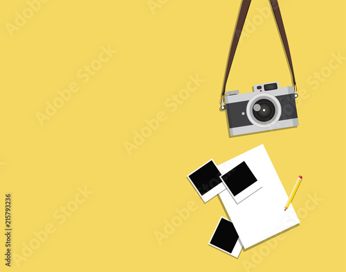 hanging old vintage camera with photos on a yellow background