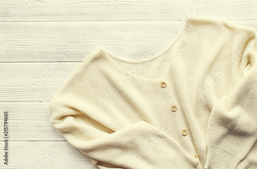 Bild auf Leinwand Fashionable easy chic casual style oversized sweater with buttons on white wood textured table background