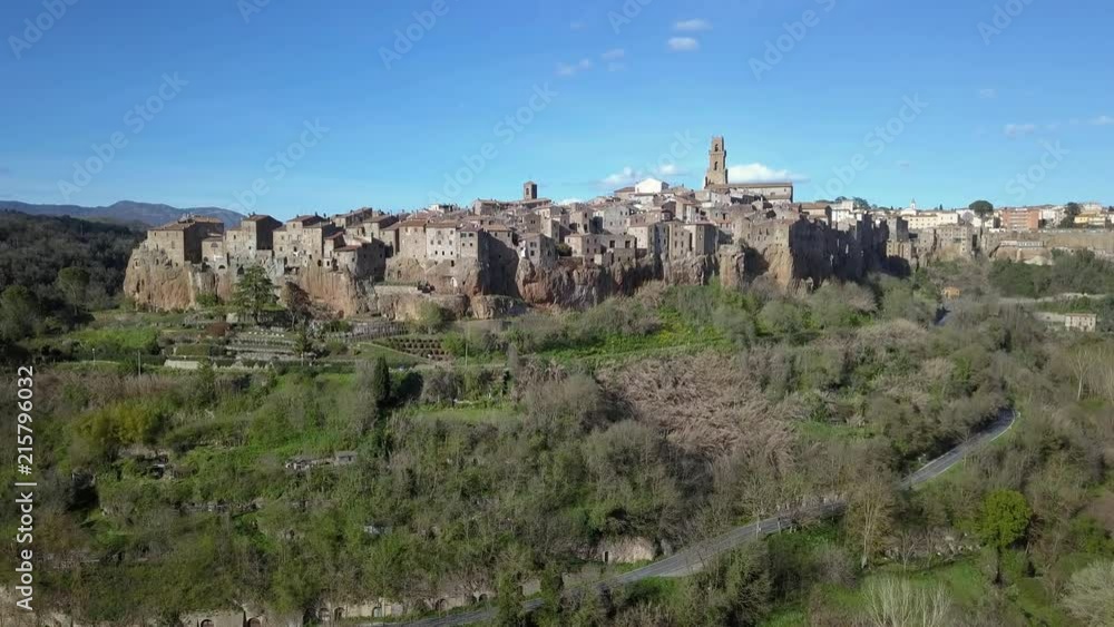 Aerial view of Pitigliano - Old Italian city, stone made, above a cliff aerial approach Aerial view of Pitigliano - Old Italian city, stone made, above a cliff aerial approach