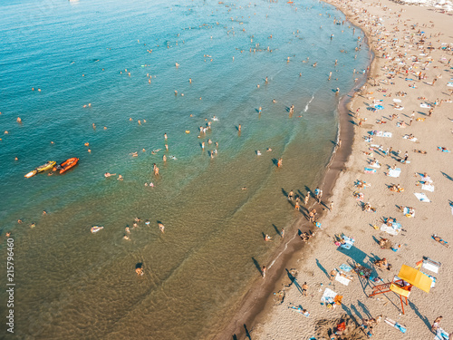 Aerial Drone View Of People Having Fun And Relaxing On Beach