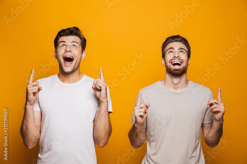 Portrait of a two happy young men best friends pointing photo