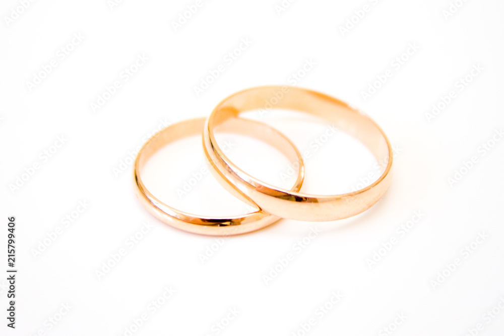 love, family, celebration, ceremony concept -wedding symbols two golden rings on white background love, family, celebration, ceremony concept -wedding symbols two golden rings on white background
