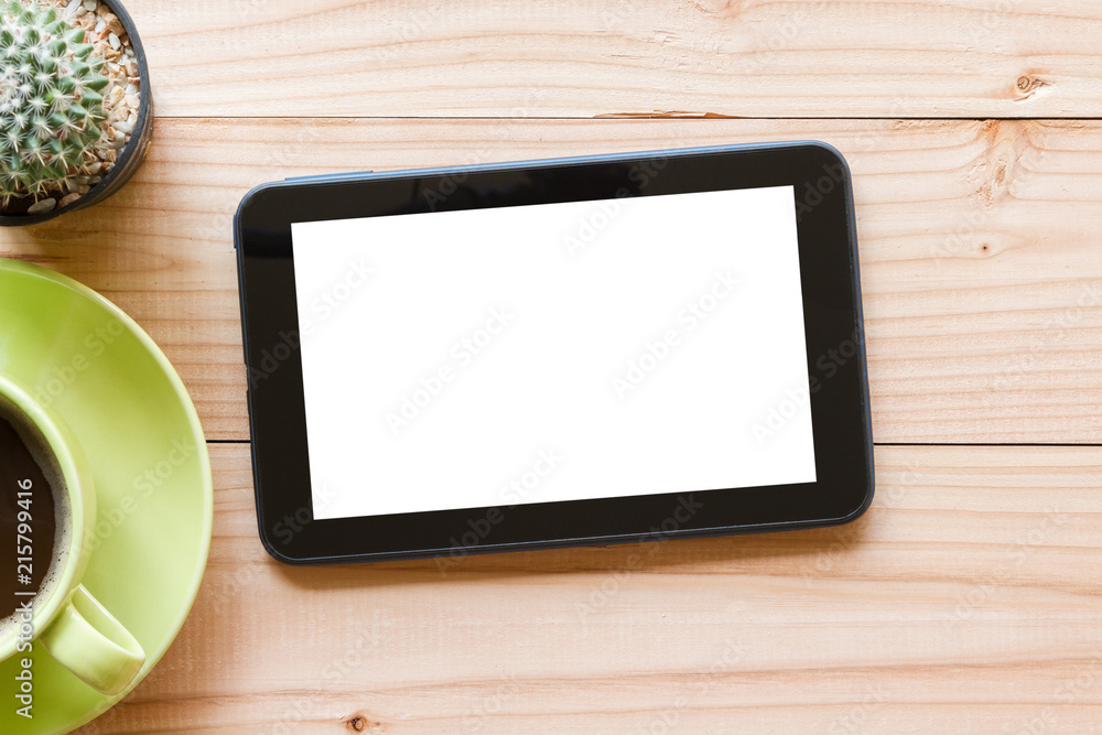 tablet computer with blank white screen on wooden background