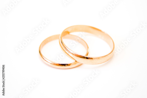 love, family, celebration, ceremony concept -wedding symbols two golden rings on white background