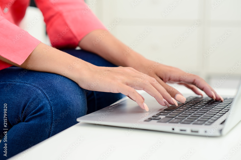 Fototapeta premium hands finger nails closeup detail of a beautiful young woman on laptop computer keyboard