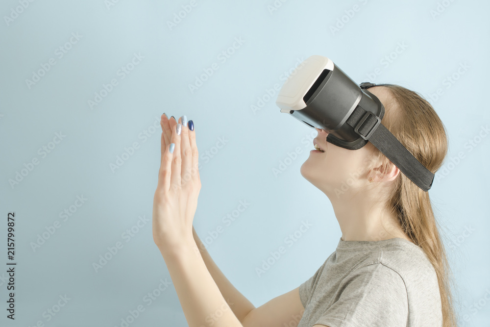 Yuong woman with glasses of virtual reality. Blue background Yuong woman with glasses of virtual reality. Blue background