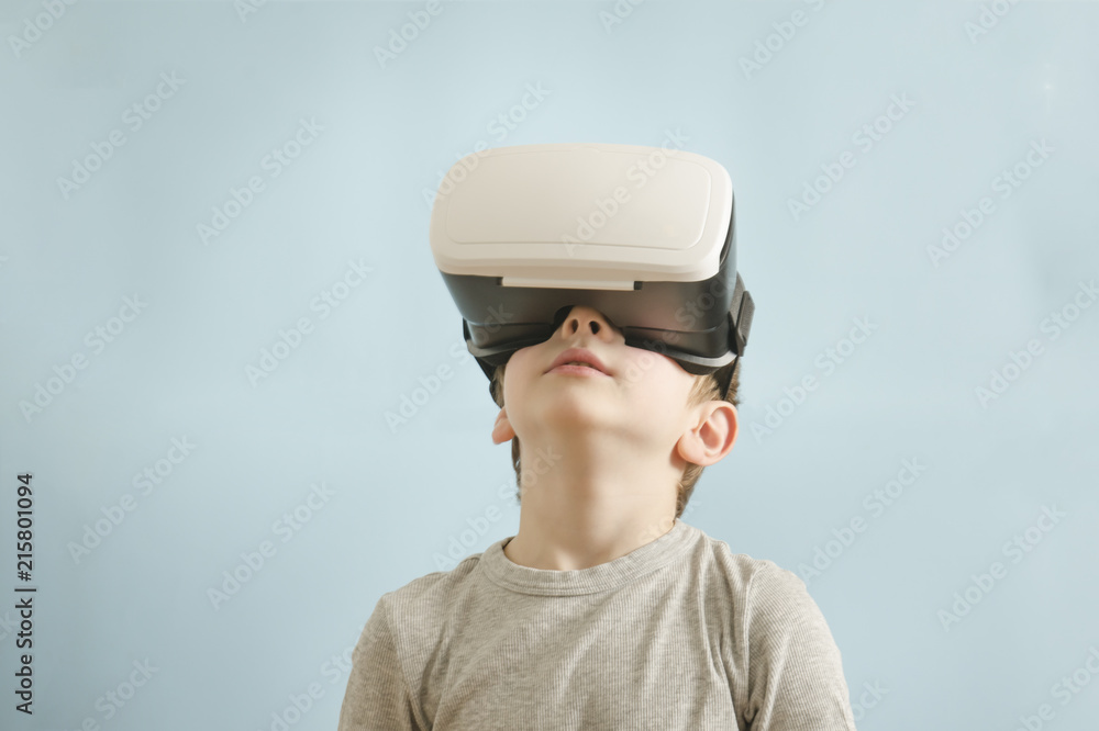 Boy with glasses of virtual reality. Blue background Boy with glasses of virtual reality. Blue background