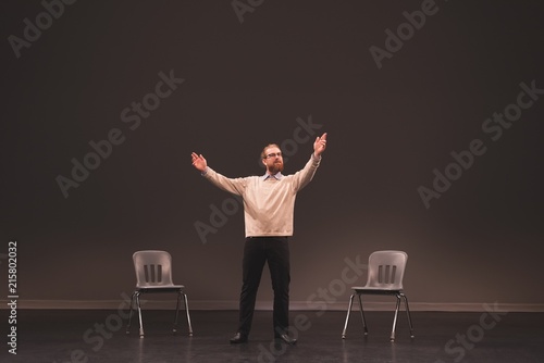 Male actor rehearsing on stage photo