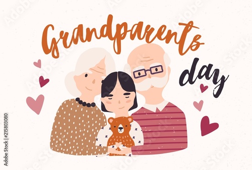 Grandfather and grandmother cuddling with grandchild