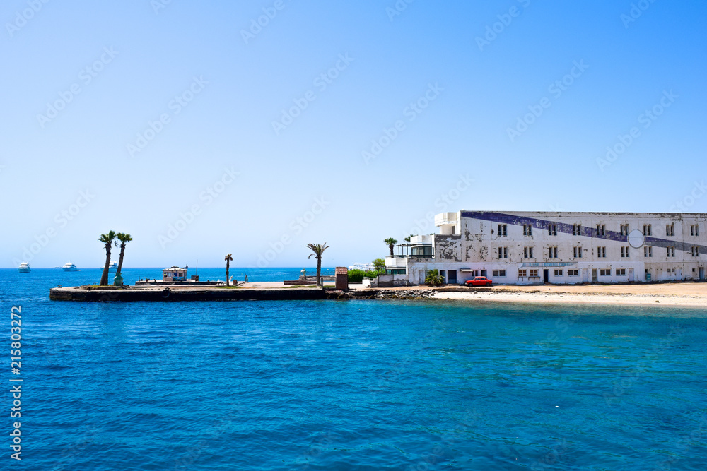 coast view, red car in front of an old house, port of Hurghada, egypt