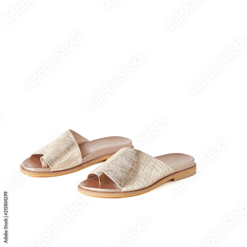 Womans golden one finger flat sandals. Studio shot, white background