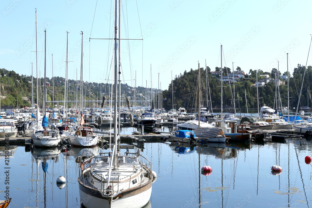 Oslo, Norway - July 22, 2018: Yachts and boats in the harbor in Oslo Fjord. Oslo harbor is located  in the inner Oslofjord, just east of the city center. 