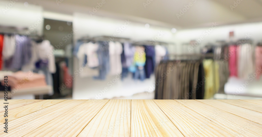 Obraz premium Empty wood table with woman fashionable boutique clothing store window display in shopping mall