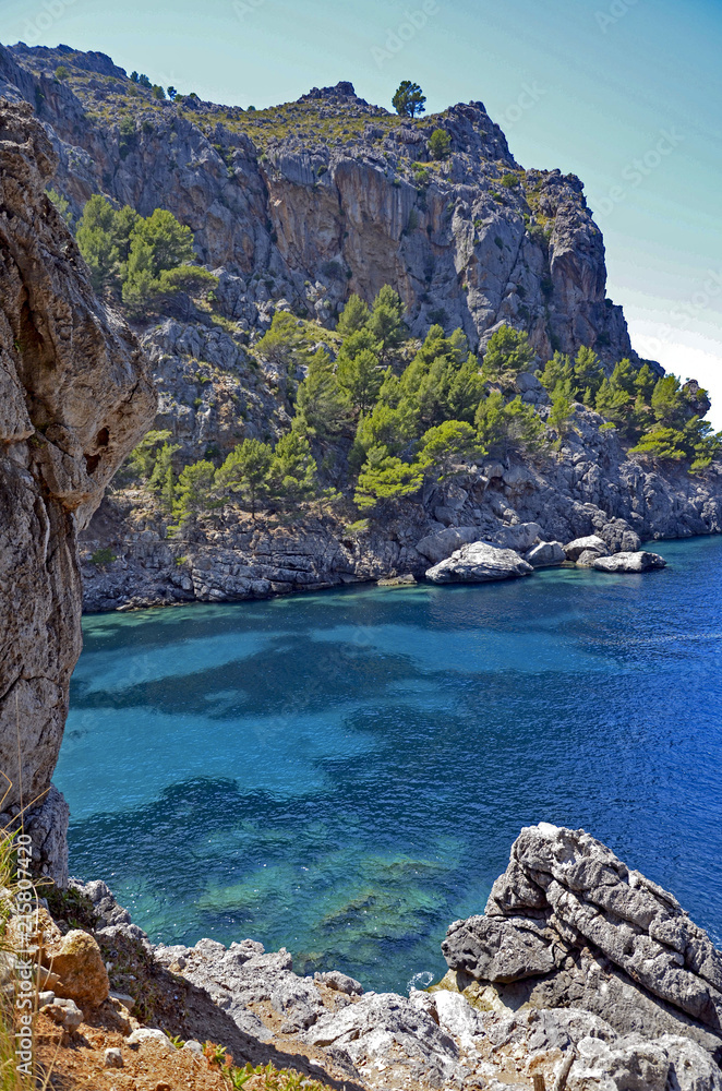 Fototapeta premium A rocky bay with turquoise water on Balearic island of Majorca, Spain