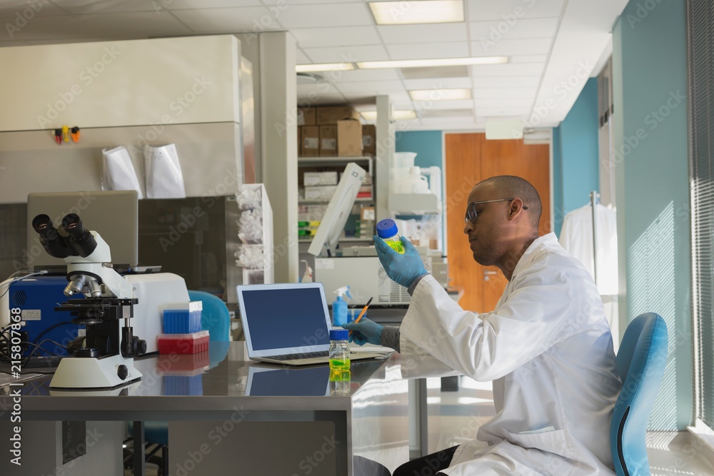 Scientist checking a chemical solution Scientist checking a chemical solution