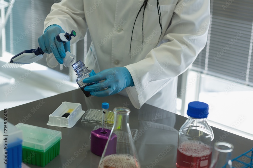 Scientist doing experiment in lab Scientist doing experiment in lab