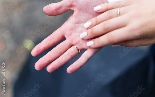 Loving couple holding hands with rings
