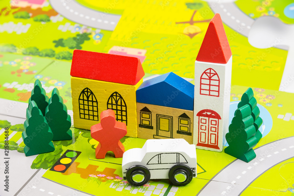 Naklejka premium Road traffic with wooden toy cars in the town on white background, safety and traffic regulations concept, backgrounds.Transportation system concept.