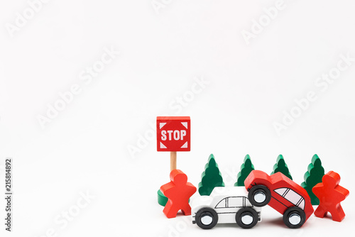Wooded toy car are crashed. Accident road traffic with wooden toy cars in the town on white background, safety and traffic regulations concept, backgrounds.Transportation system concept.