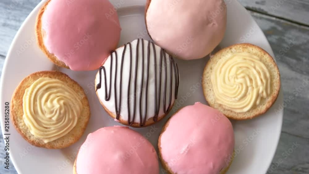 Colorful biscuits on a plate. Cookies with icing and cream. Decorated cakes filled with custard. Traditional crispy sweets. Colorful biscuits on a plate. Cookies with icing and cream. Decorated cakes filled with custard. Traditional crispy sweets.